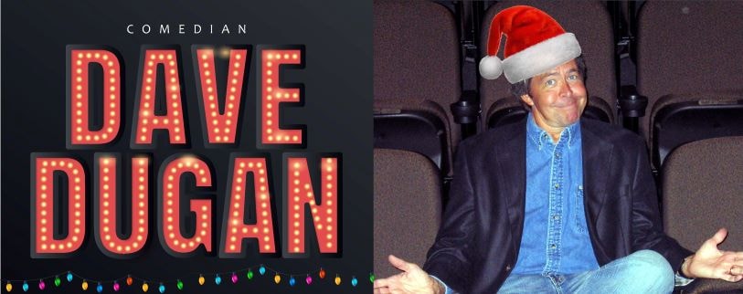 Comedian Dave Dugan in a Santa hat sitting in a theater